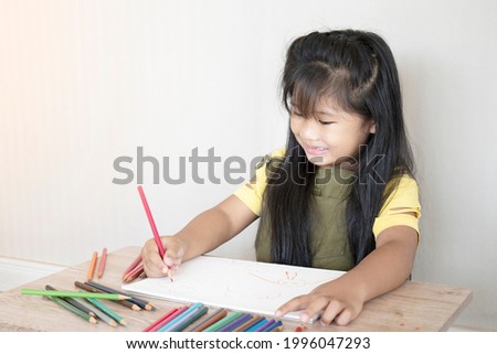 Cute little girl drawing her picture