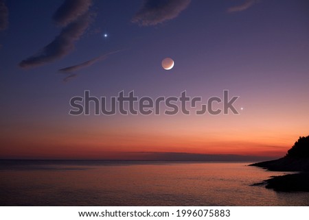 Moon and stars over sea ocean horizon.