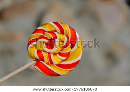 Colorful rainbow lollipop and nature background. 