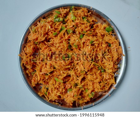 Salad with carrot and mirchi in plate with white background.