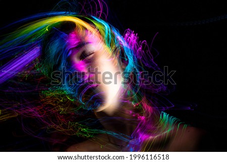Portrait in the style of light painting. Long exposure photo, abstract portrait , psychedelic poster Royalty-Free Stock Photo #1996116518