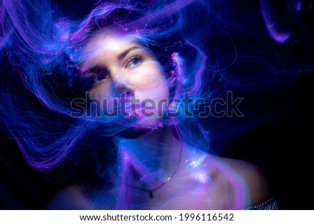Portrait in the style of light painting. Long exposure photo, abstract portrait , psychedelic poster Royalty-Free Stock Photo #1996116542