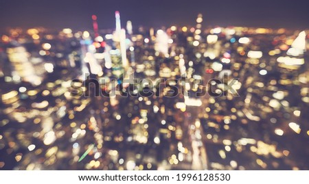 Defocused picture of Manhattan cityscape at night, color toning applied, New York City, USA.