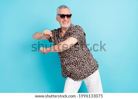Photo of cheerful charming old man dance funky mood summer vacation isolated on blue color background