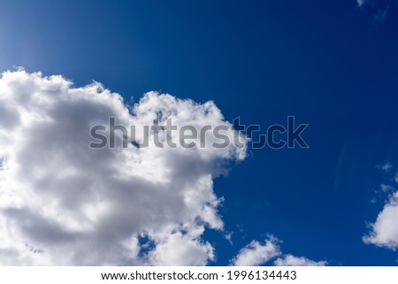 Blue sky background with white clouds.Cloudscape. Sunny day. Cumulus white cloud.the sun hiding under the clouds.