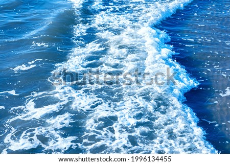 Areal shot of deep blue and rough sea with lot of sea spray.Blue background.Soft focus,blurred image.