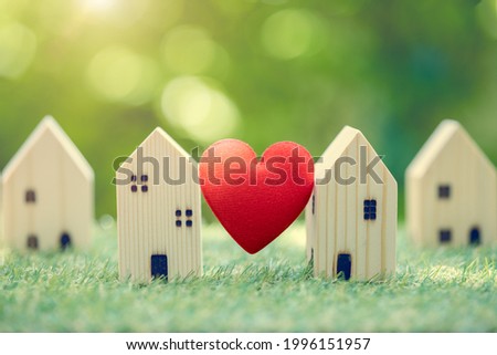 Love heart between two house wood model for stay at home for healthy community together on green fresh ecology natural environment. Royalty-Free Stock Photo #1996151957