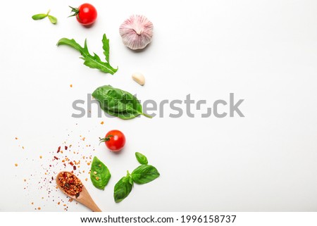 Composition with basil, tomatoes and spices on white background Royalty-Free Stock Photo #1996158737