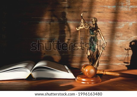 statue of justice, book and gavel on wooden table. trial concept