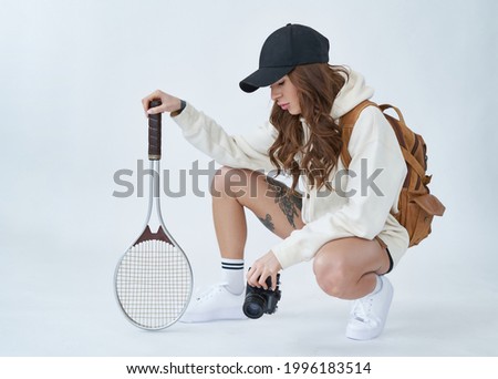 Young fitness woman with sports equipment and baseball cap