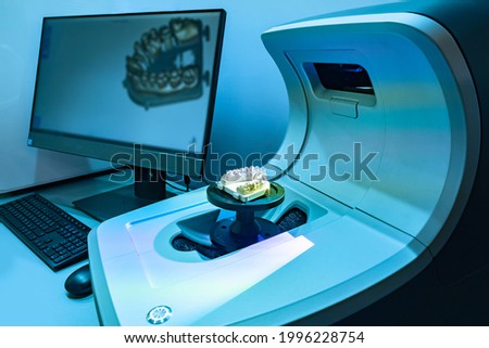 3D scanner in a dental laboratory. 3D scanner creates a virtual image of denture. Three-dimensional picture of denture on computer screen. Work equipment of prosthetist. Dental prosthetist scanner.