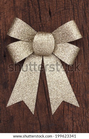 Stock Photo - gold Bow  With Wooden Wall