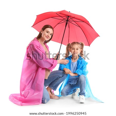 Mother and little daughter with umbrella on white background