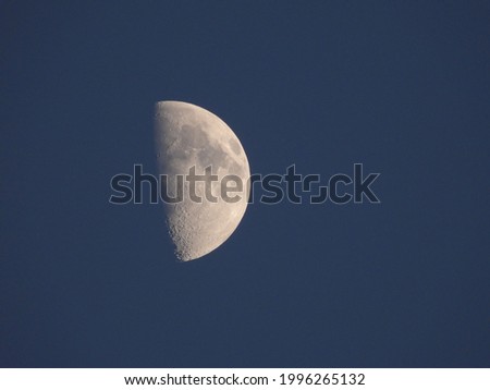 closeup of half moon with blue sky background