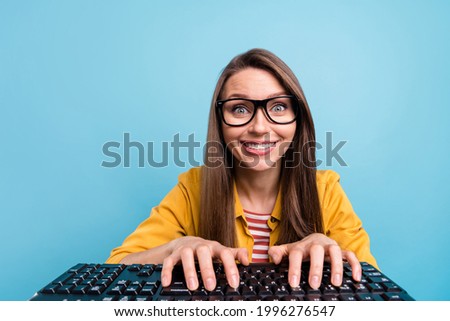 Photo of young attractive woman happy positive smile developer keyboard computer isolated over blue color background