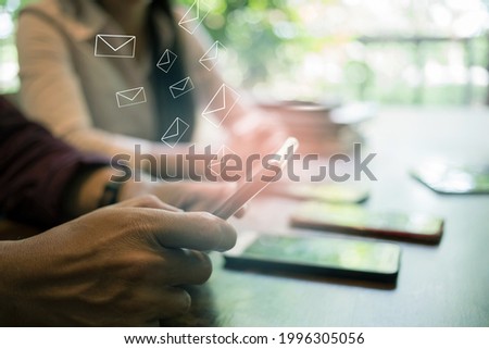 newsletter concept Hand of businessman checking message box on smartphone Vintage tone filter.