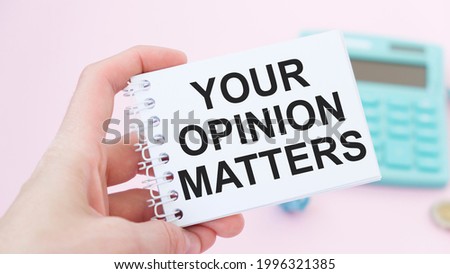 Closeup on businessman holding a card with text YOUR OPINION MATTERS, business concept image with soft focus background and vintage tone