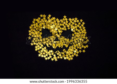 Poster with golden pumpkin silhouette from stars glitter.