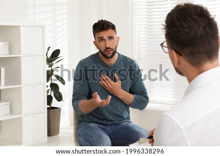 Psychotherapist working with drug addicted man indoors Royalty-Free Stock Photo #1996338296