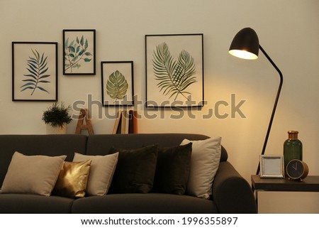 Stylish living room interior with comfortable sofa and floor lamp