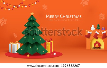 Orange Xmas card in paper cut style. Illustration of Christmas tree with gifts, snowflakes, and hanging stockings on fireplace over orange background