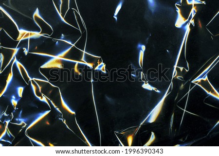 Beautiful darkness plastic abstract background. No plastic bag concept, save world, protect earth. Freeze motion of dark powder exploding. Glossy polyethylene. plastic transparent. Space for text.  Royalty-Free Stock Photo #1996390343
