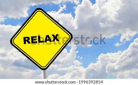 time to relax sign on cloudy sky background