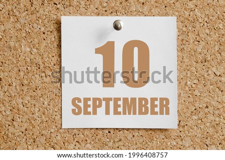 september 10. 10th day of the month, calendar date.White calendar sheet attached to brown cork board. Autumn month, day of the year concept.