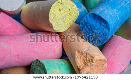 colored chalks arranged diagonally over a white background