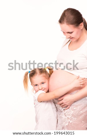 Happy child holding belly of pregnant woman isolated on white background