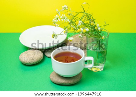 Creative photography of tea on a colored background. A cup of soothing tea.