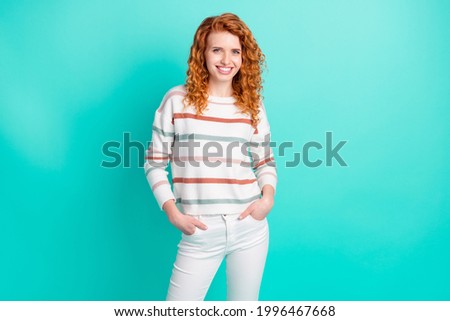 Photo of cool orange wavy hair young lady stand wear sweater pants isolated on teal color background