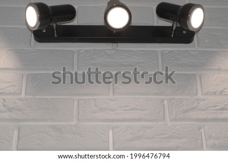 
black lamp on a white brick wall