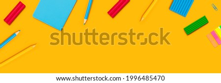 Back to school web banner. Writing materials on yellow background.