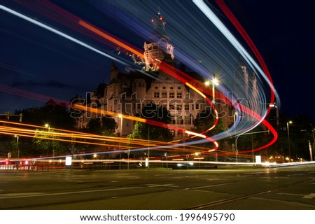 Town hall in Leipzig (Germany) at night, Taken at an intersection with a passing bus, long exposure with light trails