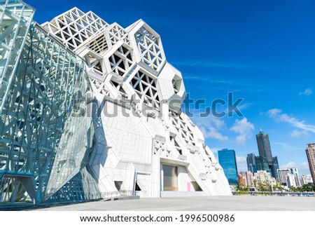 Kaohsiung, Taiwan- May 8, 2021: Kaohsiung Music Center with the view from Love River. The white hexagonal building structure on the riverbank in Kaohsiung, Taiwan. Royalty-Free Stock Photo #1996500986