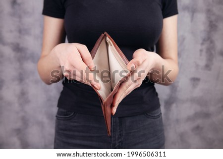 young woman showing empty wallet