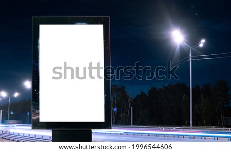 Modern billboard with a blank white screen on a busy highway with traffic, neon lights. Empty billboard for advertising. Moscow, Russia