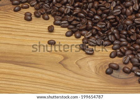 Coffee beans over wooden background