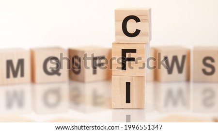 wooden cubes with word CFI arranged in a vertical pyramid, on the white background is a row of wooden cubes with letters, business concept. CFI - short for custom factory integration