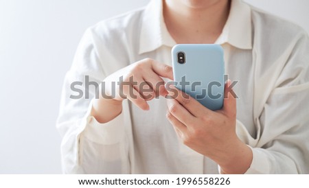 Middle-aged Asian women using smartphones