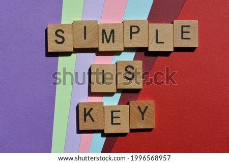 Simple is Key, words in wooden alphabet letters isolated on colourful background