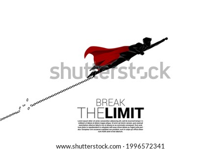 Silhouette of businessman flying to break the chain at foot. Concept of break the rule and limit in business. Royalty-Free Stock Photo #1996572341