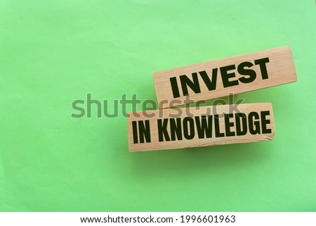 Investing In Knowledge words on wooden blocks. Education concept.