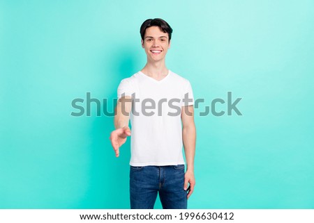 Photo portrait young guy in white t-shirt giving hand greeting meeting isolated bright teal color background