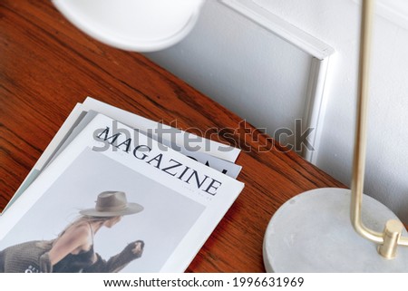 Magazine on a wooden table Royalty-Free Stock Photo #1996631969