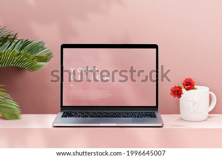 Laptop mockup with a pastel pink wall Royalty-Free Stock Photo #1996645007