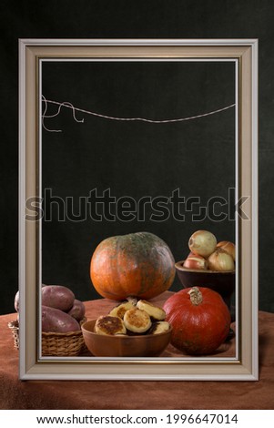 Still life in a frame with fried cheesecakes and vegetables