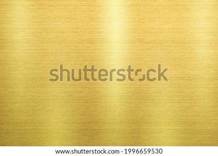 Shiny gold polished metal background texture of brushed stainless steel plate with the reflection of light. Royalty-Free Stock Photo #1996659530
