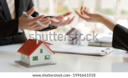 Real estate business, sales representatives offer home purchase contracts to buy a house or apartment, or discuss loans and interest rates, home and rent sales ideas.